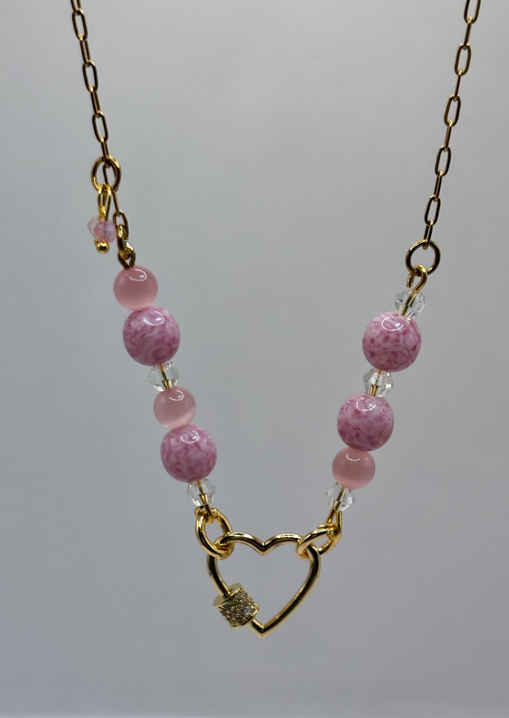 Pink marbled beaded necklace with gold heart clasp.