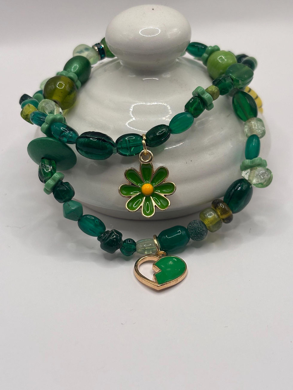 Green glass bead bracelet with flower and heart charms