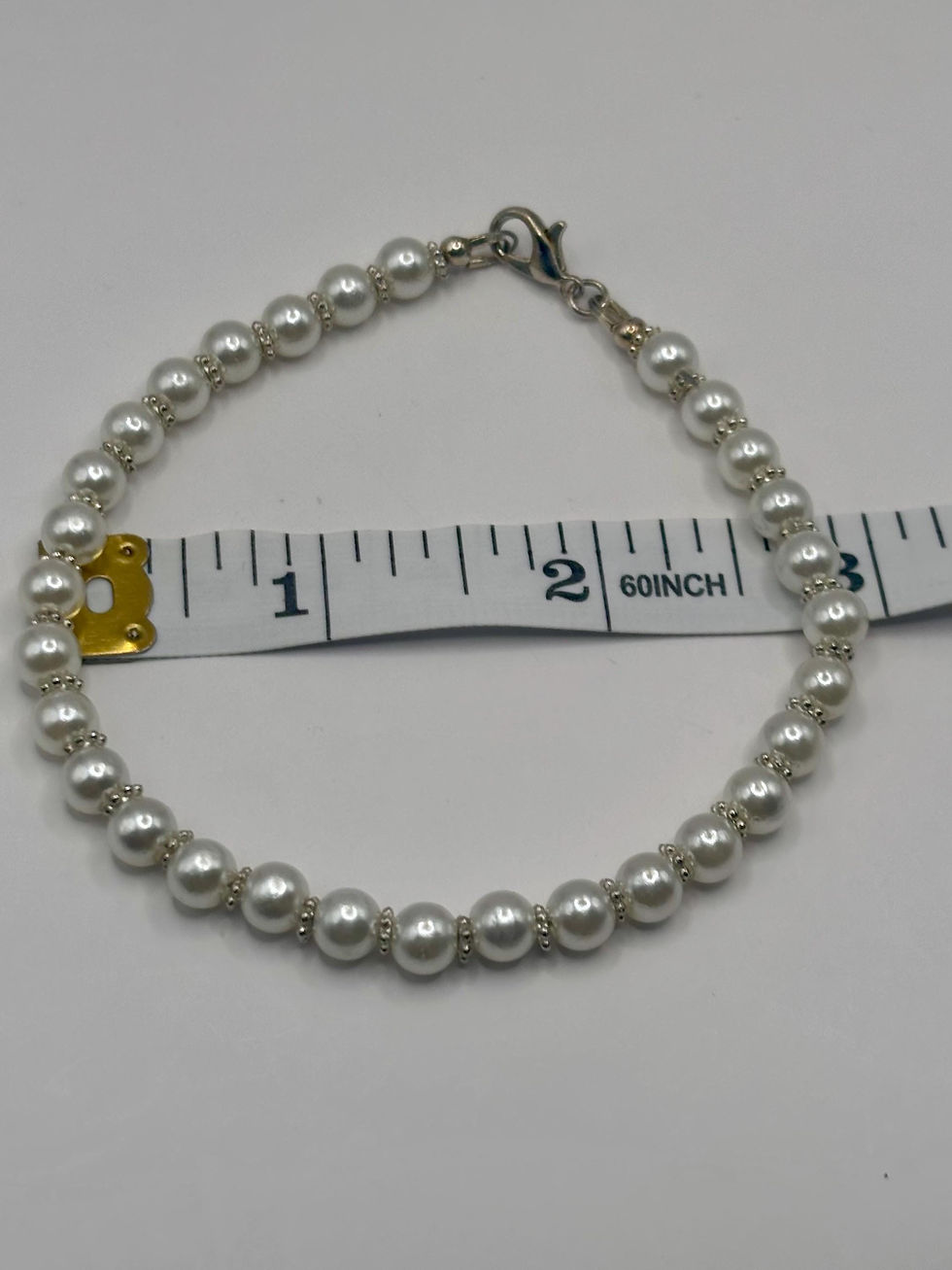 Thumbnail: Pearl bead bracelet shown with a 3-inch measuring tape.
