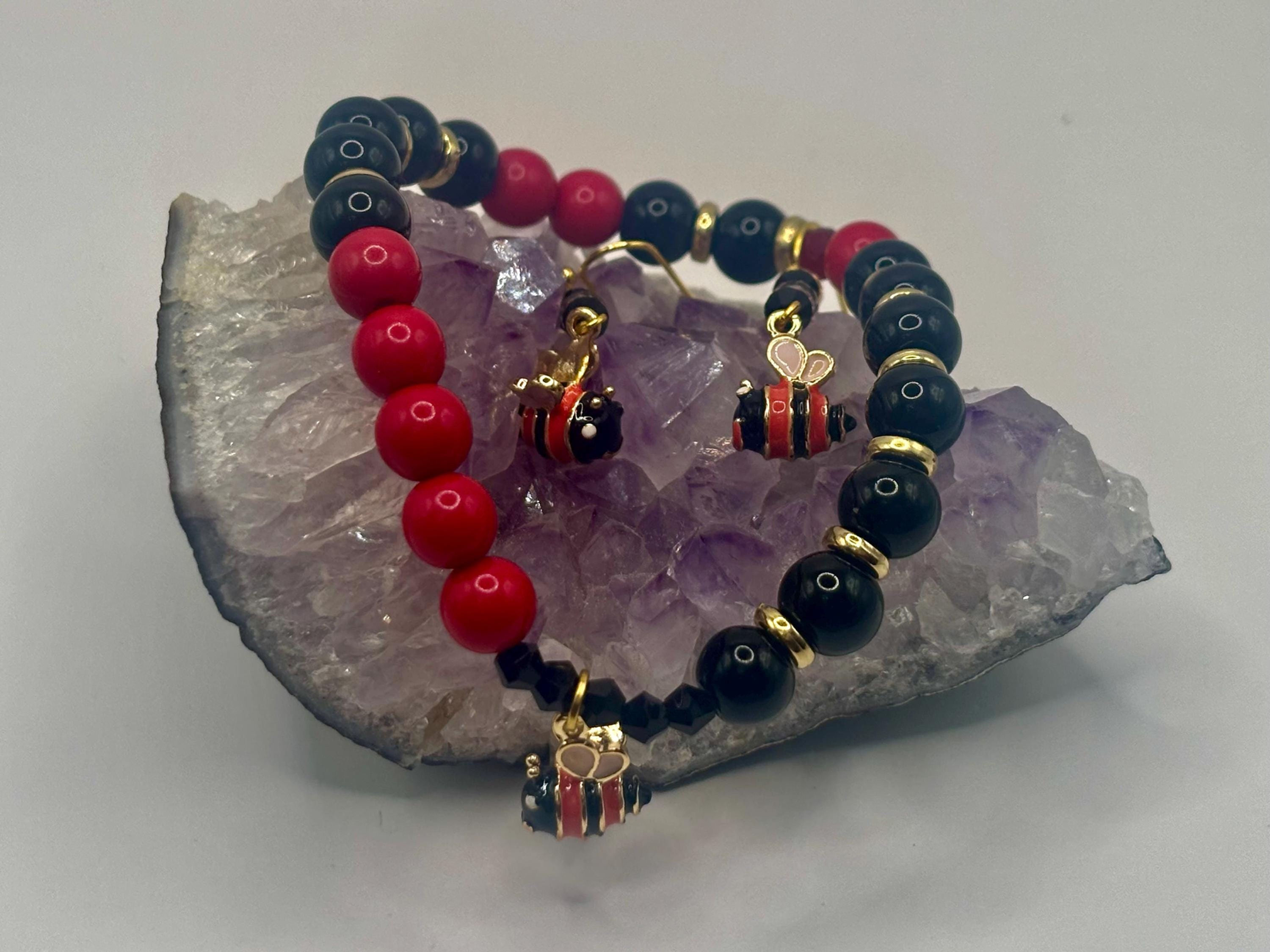 Handmade pink, black and gold bee charm bracelet with earrings.