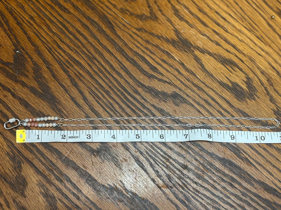 Thumbnail: Silver carabiner necklace with beads shown against a ruler