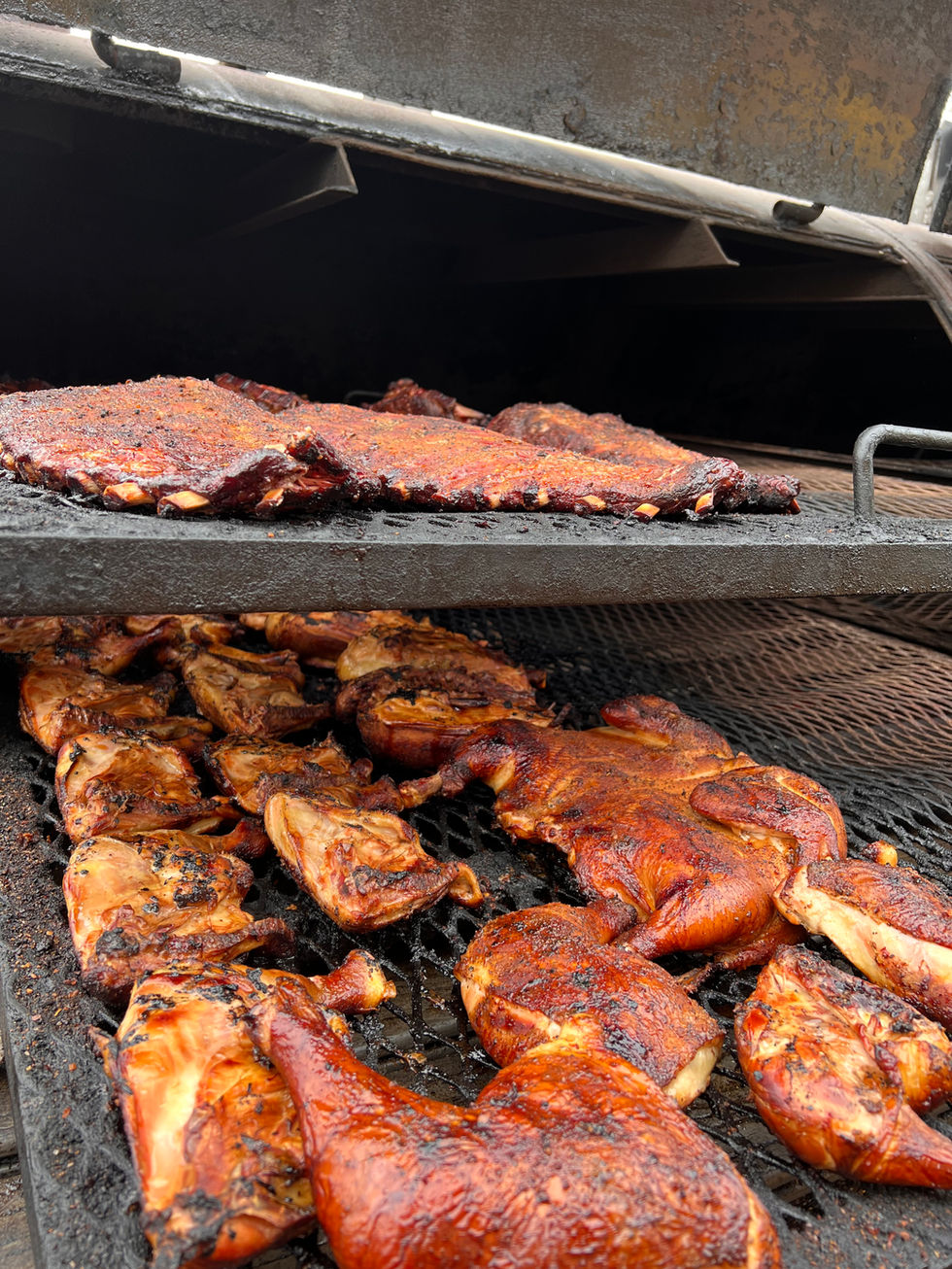 Another sweet picture of chicken leg quarters and ribs on the grill!
