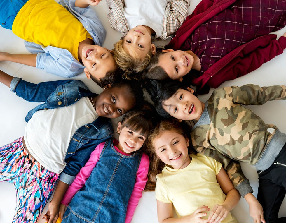 Happy group of kids and friends lying in a circle looking up at camera - Keeba Media