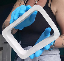 cath holding a handmade square vase