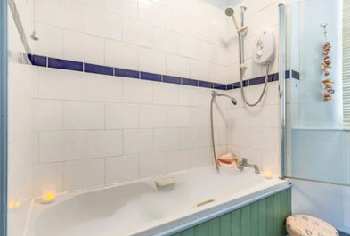 En-suite with Shower Cubicle, Toilet and Heated Towel Rail.