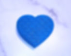 Blue glittery heart-shaped bath bomb with embossed mermaid scale design