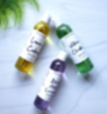 Three bottle of body wash laying flat