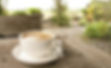 coffee-cup-on-table-with-garden-view-background-free-photo.jpg