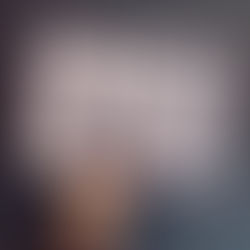 A hand holds up an image against a dark green background. The image is a caricature of a man and woman drawn in black marker pen.