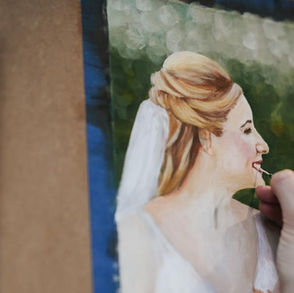 A zoomed in photograph of an artist painting from a digital image which sit side by side.