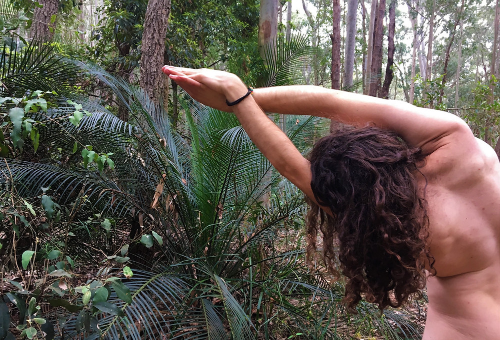naked man in rainforest doing yoga