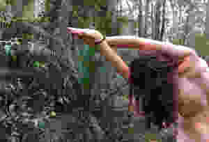 naked man in rainforest doing yoga