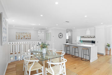 new white kitchen in renovating with new staircase and wooden floors