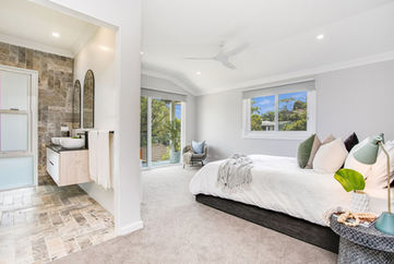 new extension of master bedroom with a modern bathroom with stone tiles