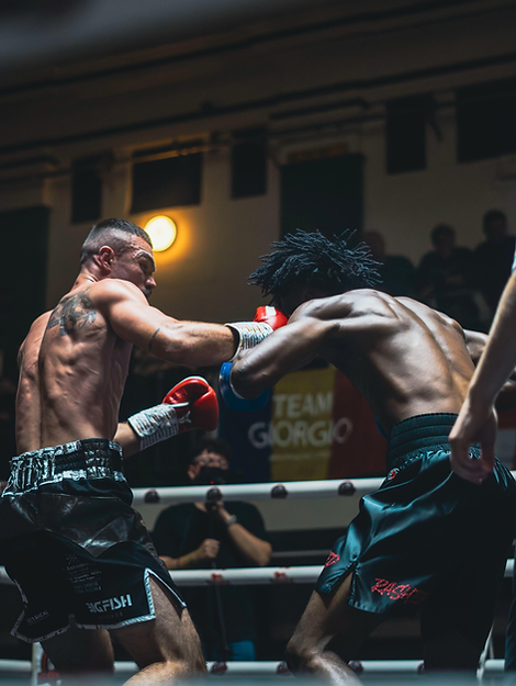 Joel Bartell in Bespoke GG shorts in a mid-fight action shot.