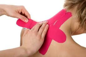 Kinesio tape being applied to neck and shoulders