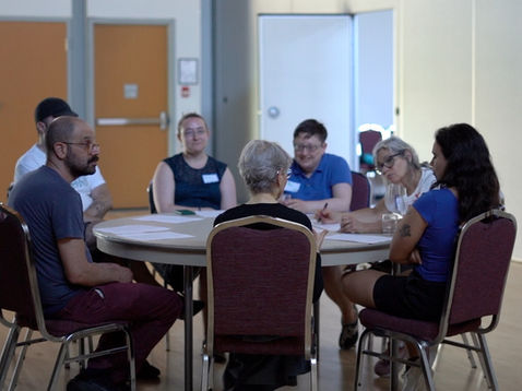 Peretz members sitting around a table in the midst of a discussion