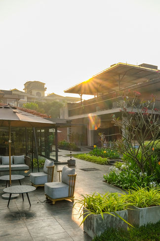 Modern tropical architecture and outdoor seating area at Amaraanth luxury boutique hotel in Goa during golden hour