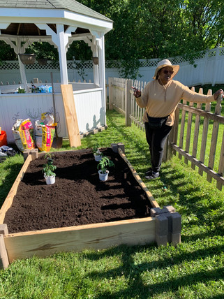 Miss Chris beside our new vegetable bed. Don't let the adorable hat fool you... She is a wealth of wisdom for all things gardening!