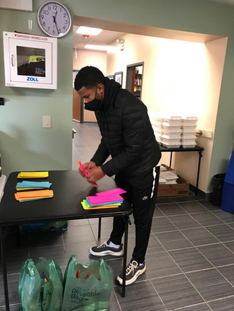 Gabe Cheeks sorting Dayenu info sheets.
