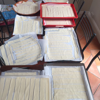 Pappardelle strips cut by hand and laid onto trays to air dry