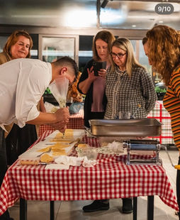 Chef demonstrates how to pipe the ravioli filling onto pasta sheet