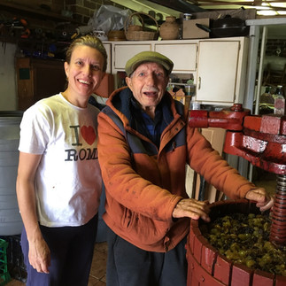 Wine making with dad, we stand at the wine press.