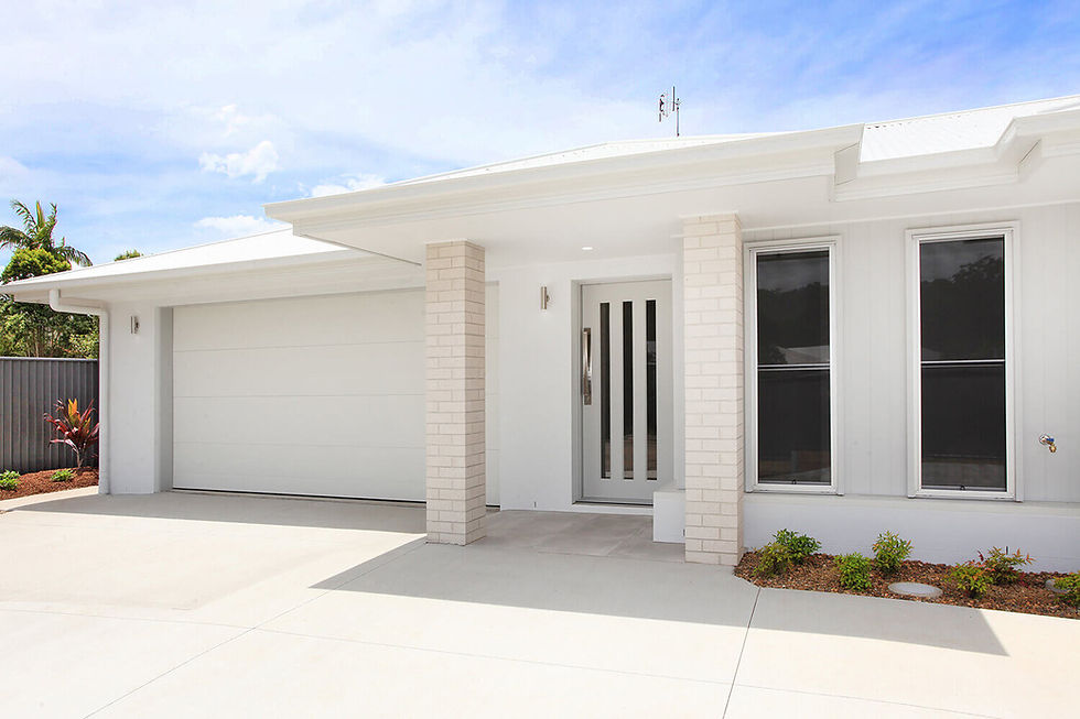 A modern duplex with two separate entrances, with low maintenance landscaping, and a spacious driveway, ideal for dual living or rental income