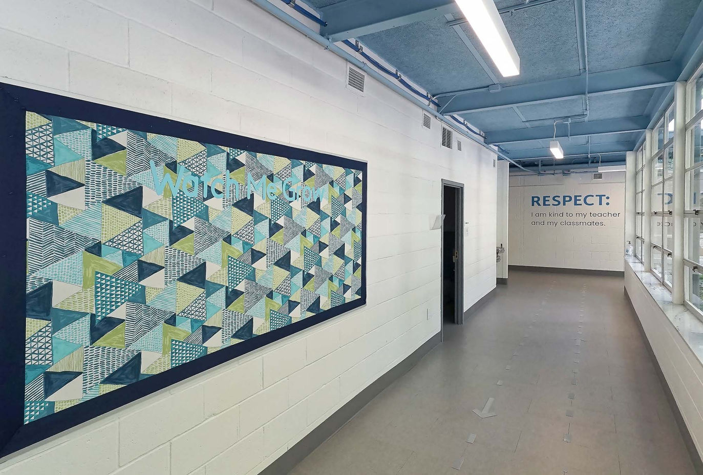 Spacious hallway at Ethos Classical with big artworks on wall