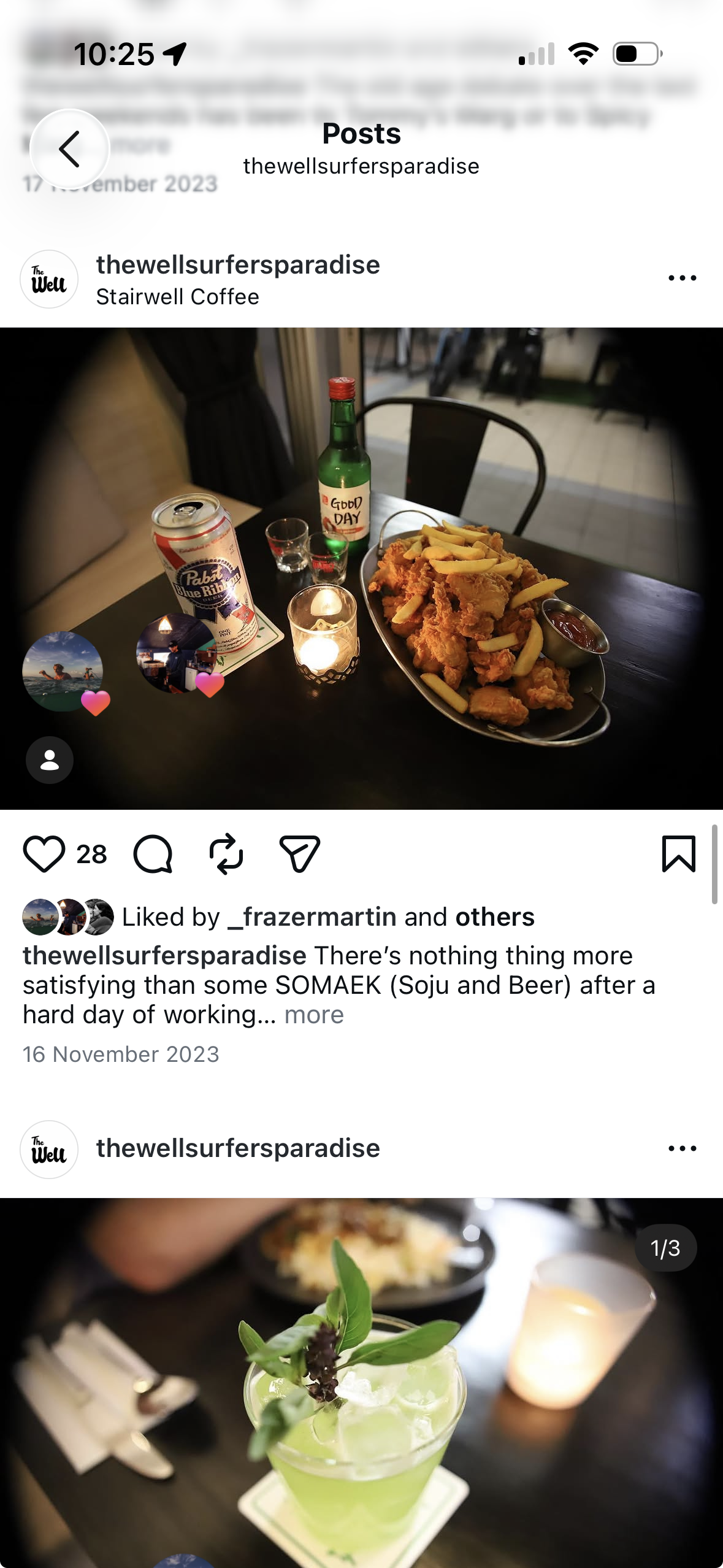 Fried chicken and chips beside a candle and a bottle of soju at The Well
