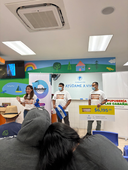 Donation presentation event at Ayúdame a Vivir foundation with attendees gathered indoors