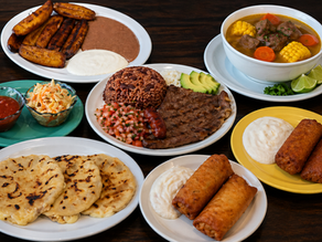 Traditional Salvadoran dishes including pupusas, carne asada, sopa de res, fried plantains, and tamal de elote served at Pupusería Las Cabañas in Hayward.