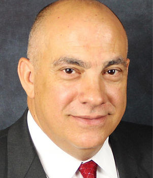 Blonde woman smiling wearing a blue jacket and a white shirt