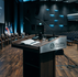 An empty podium in a big theater with the national flags of Korea, Canada, and the US