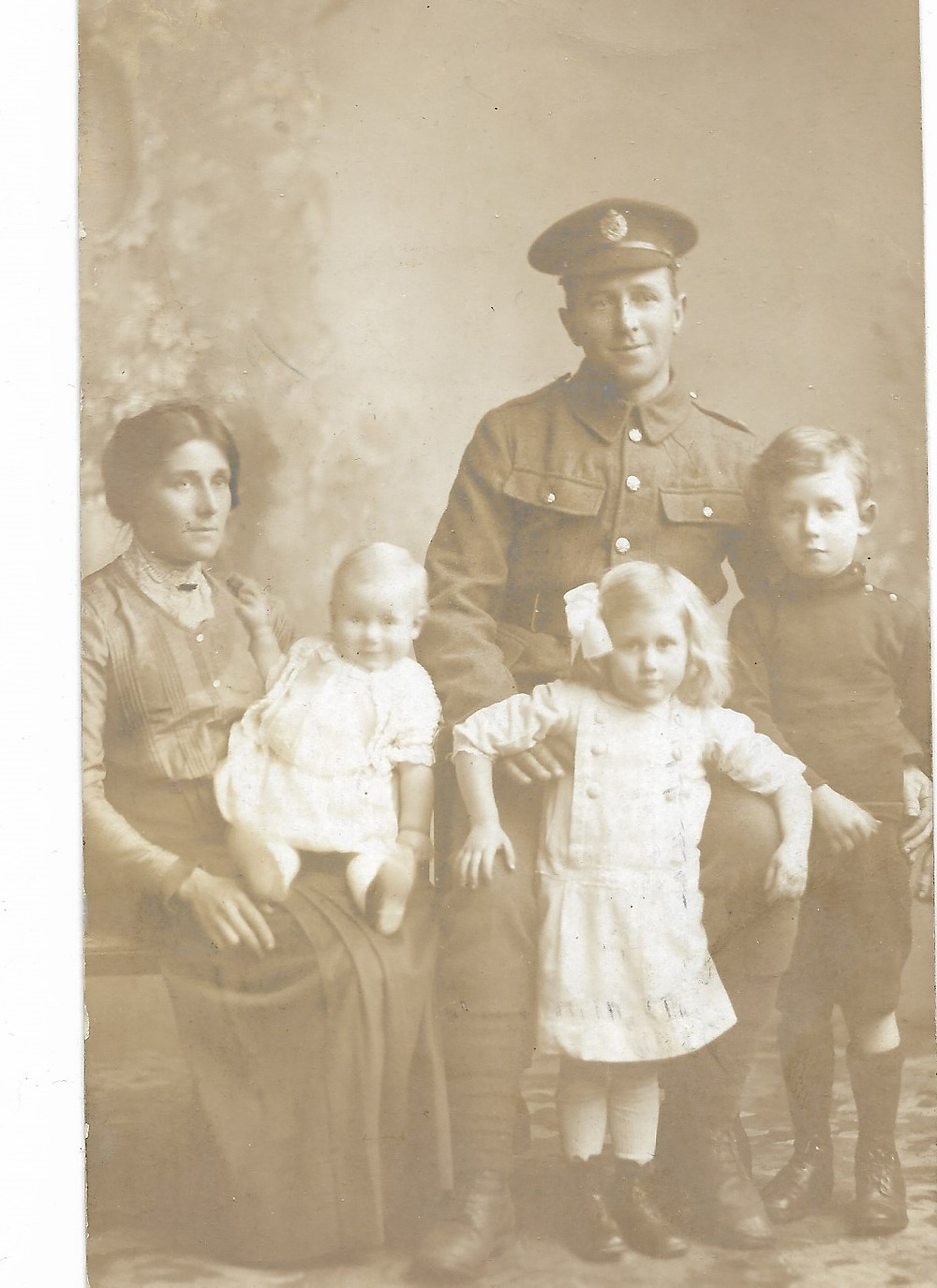 Caleb Brown Smith in uniform with his wife and 3 children.