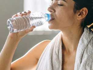 women drinking bottled water