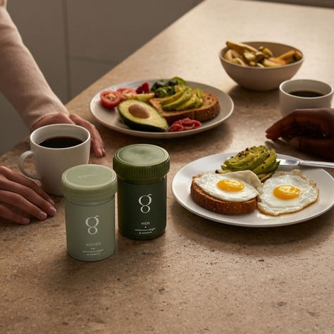Greenhaus supplements sitting on a counter with breakfast and two people sharing the moment