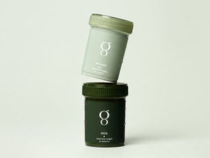 Greenhaus womens vitamins bottle balancing on mens vitamins bottle