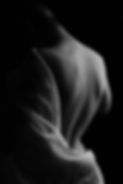 Sensual silhouette of a woman’s back in soft lighting — artistic image used in Eros Center