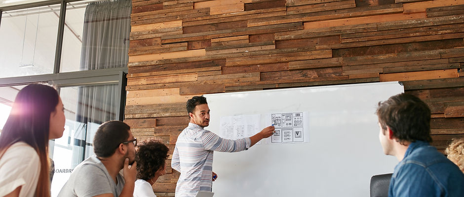Young Man Presenting New App Design To Colleagues.jpg