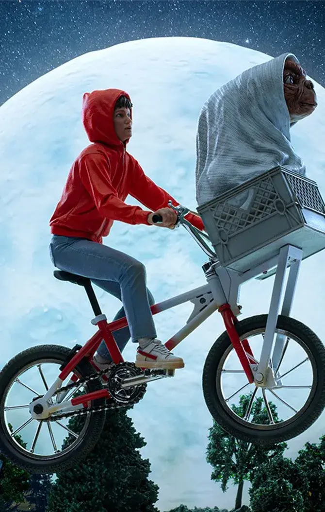 a boy and ET on a bike flying.