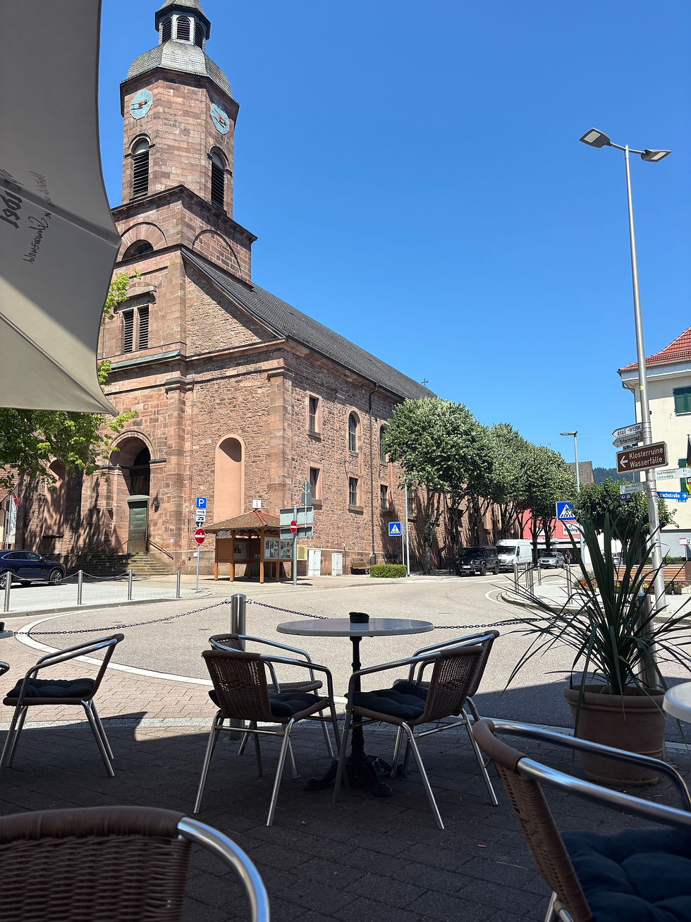 At a road junction drinking beer and eating ice cream watching the world go by.