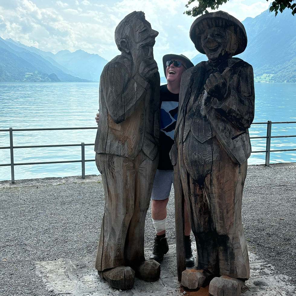 larger than life wood carvings alongside Lake Brienz