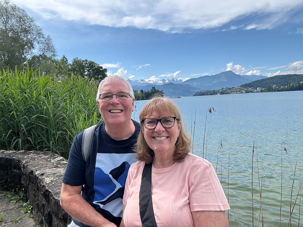 Karen and Michael sat on the low wall of Lake Lucerne