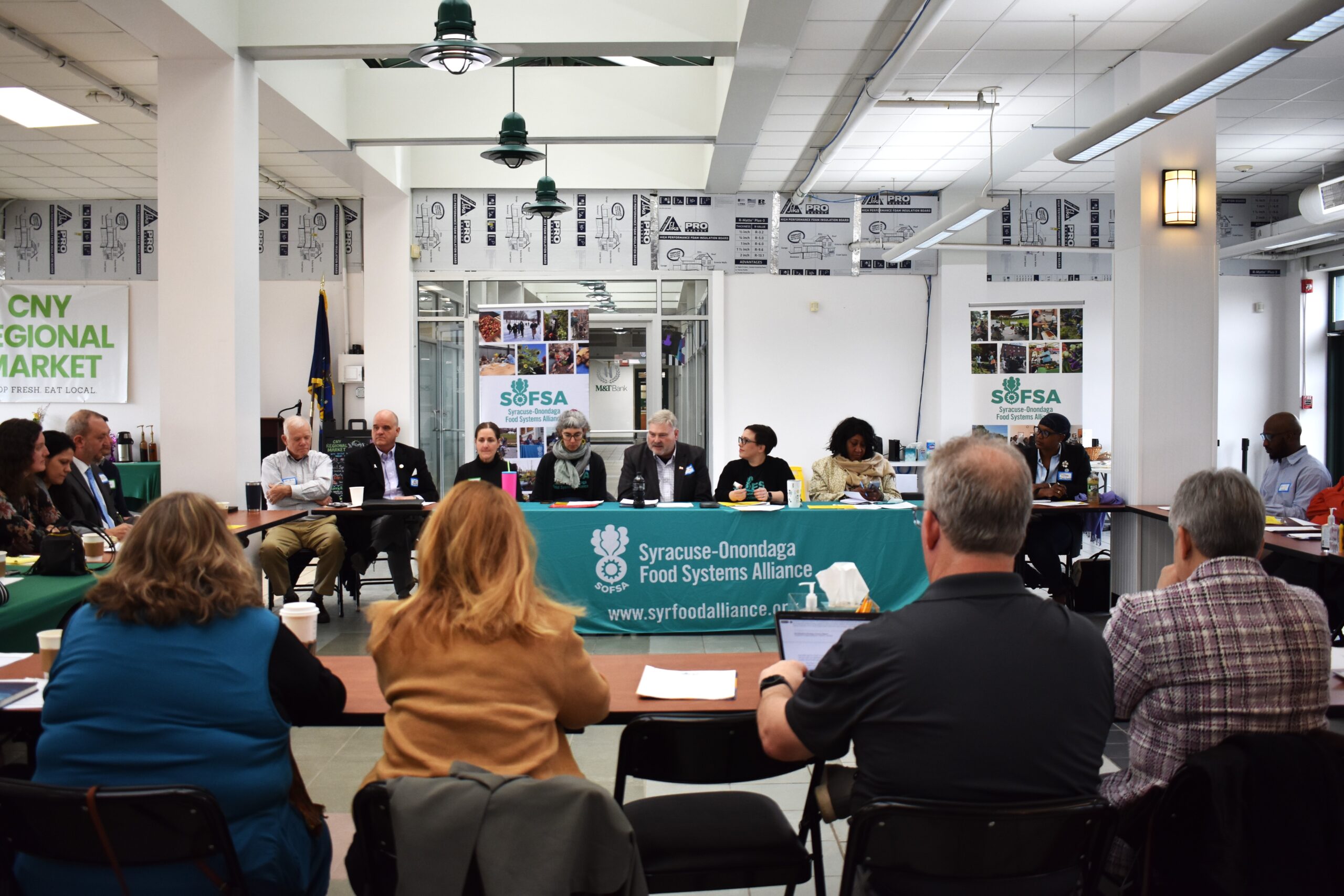 County Legislator David Knapp sits next to SOFSA Director Maura Ackerman as they address 50 food system leaders and elected officials