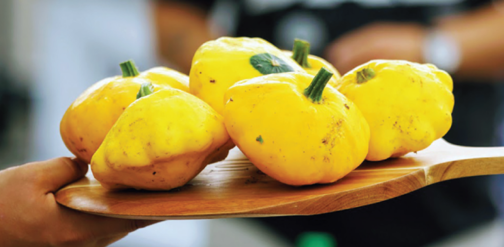 Patty pan squash on wooden cutting board