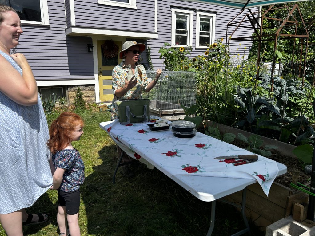 Heather offers elderflower soda to the group and shares about her sunflower-loving goldfinch friends.
