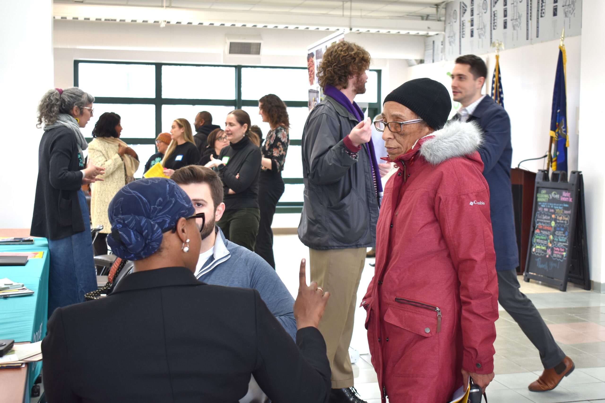 People in a room talk to each other in small groups.