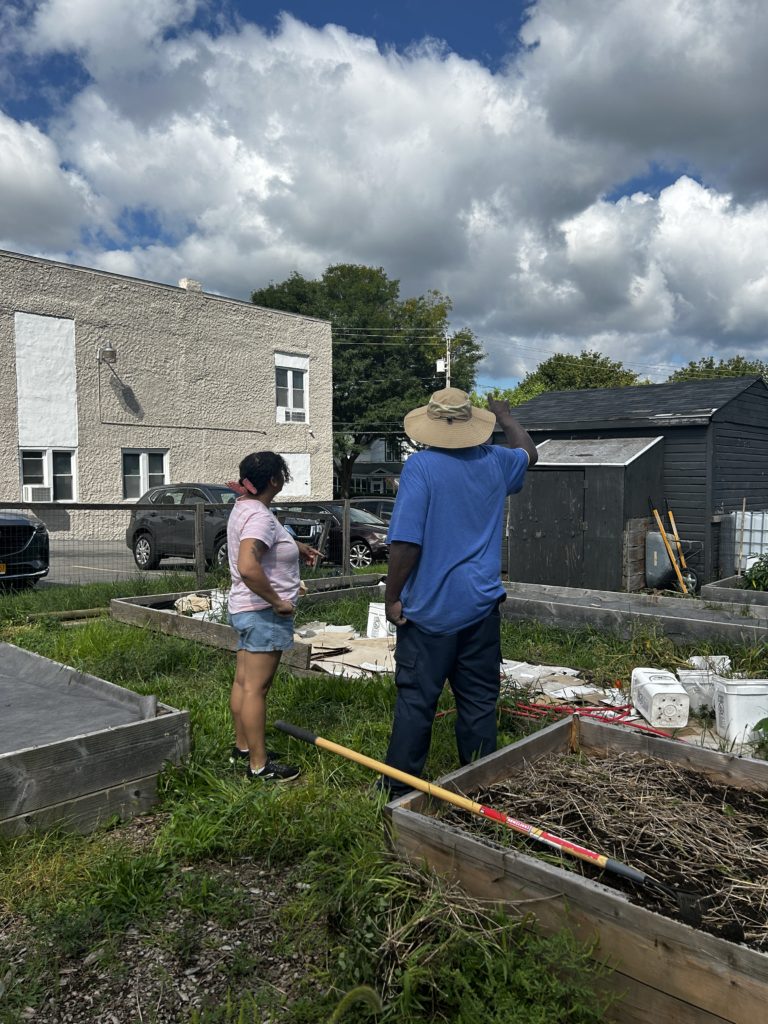 Wes illustrates for Kayla his plans for solar installation on the shed roof.