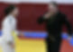 A man and a woman at ju-jitsu class laughing and having fun